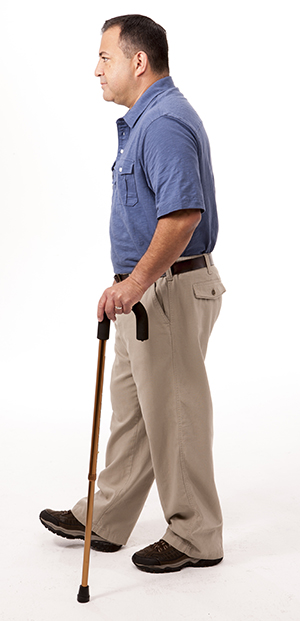 To check fit: Place the tip 2 inches in front and 6 inches to the side. Man walking with cane.