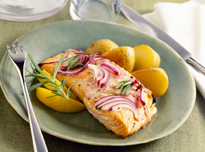 Plate of grilled fish and small serving of potatoes.